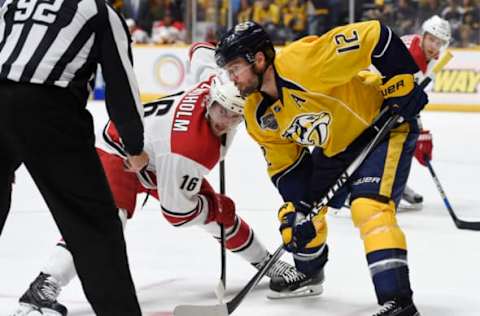 NASHVILLE, TN – OCTOBER 8: Mike Fisher #12 of the Nashville Predators and Elias Lindholm #16 of the Carolina Hurricanes await the drop of the puck by linesman Mark Shewchyk #92 at Bridgestone Arena on October 8, 2015, in Nashville, Tennessee. (Photo by Sanford Myers/Getty Images)