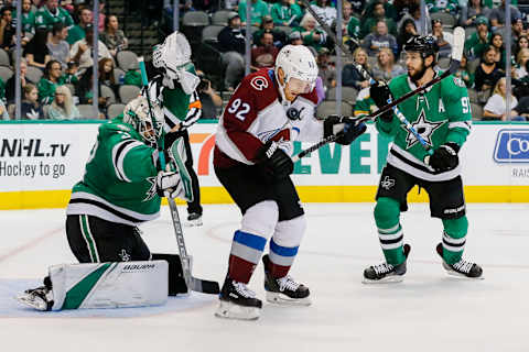 DALLAS, TX – SEPTEMBER 30: Colorado Avalanche left wing Gabriel Landeskog (92) gets hit in the chest by a puck in front of Dallas Stars goalie Colton Point (32) as Dallas Stars center Tyler Seguin (91) looks on during the game between the Dallas Stars and the Colorado Avalanche on September 30, 2018 at the American Airlines Center in Dallas, Texas. Colorado defeats Dallas 6-5. (Photo by Matthew Pearce/Icon Sportswire via Getty Images)