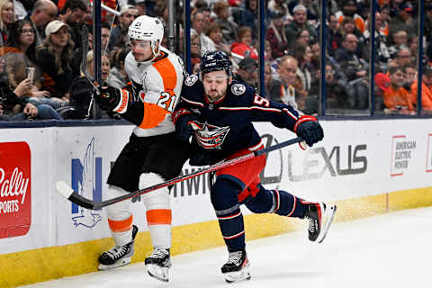 Nov 10, 2022; Columbus, Ohio, USA; Columbus Blue Jackets right wing Emil Bemstrom (52) checks Philadelphia Flyers center Scott Laughton (21) against the boards in the second period at Nationwide Arena. Mandatory Credit: Gaelen Morse-USA TODAY Sports