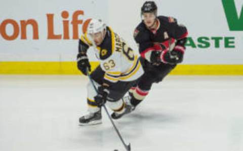 Nov 24, 2016; Ottawa, Ontario, CAN; Boston Bruins left wing Brad Marchand (63) skates with the puck in front of Ottawa Senators center Kyle Turris (7) in the third period at the Canadian Tire Centre. The Senators defeated the Bruins 3-1. Mandatory Credit: Marc DesRosiers-USA TODAY Sports