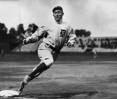 circa 1915: Full-length image of Detroit outfielder Ty Cobbb (1886 – 1961) touching third base while running during a baseball game. (Photo by Hulton Archive/Getty Images)