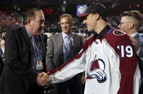 VANCOUVER, BRITISH COLUMBIA – JUNE 22: Alex Beaucage, 78th overall pick of the Colorado Avalanche, is greeted at the draft table by Brad Smith during Rounds 2-7 of the 2019 NHL Draft at Rogers Arena on June 22, 2019 in Vancouver, Canada. (Photo by Dave Sandford/NHLI via Getty Images)