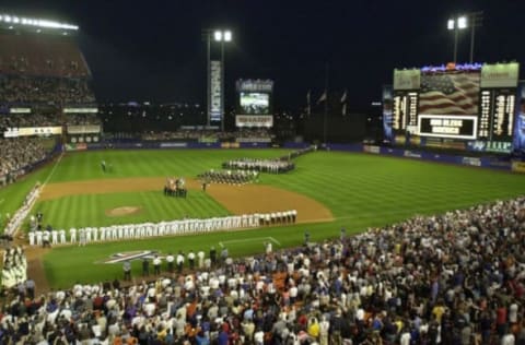 The New York Mets and Atlanta Braves stand on the foul lines during the pre-game ceremonies 21 September 2001 at Shea Stadium in New York, as the Mets play their first home game after the attack on the World Trade Center and the Pentagon 11 September. Diana Ross sang “God Bless America” and rescue workers from New York City agencies were honored. AFP PHOTO/Stan HONDA (Photo by STAN HONDA / AFP) (Photo credit should read STAN HONDA/AFP via Getty Images)