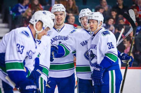 Apr 7, 2016; Calgary, Alberta, CAN; Vancouver Canucks defenseman Nikita Tryamkin (88) celebrates his goal with teammates against the Calgary Flames during the first period at Scotiabank Saddledome. Mandatory Credit: Sergei Belski-USA TODAY Sports