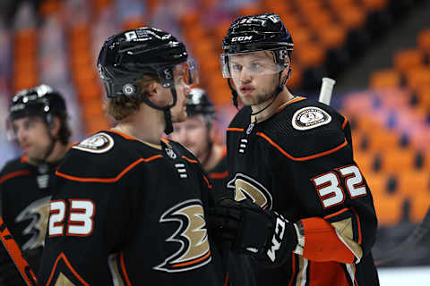 Jacob Larsson #32 talks with Sam Steel #23 of the Anaheim Ducks (Photo by Sean M. Haffey/Getty Images)