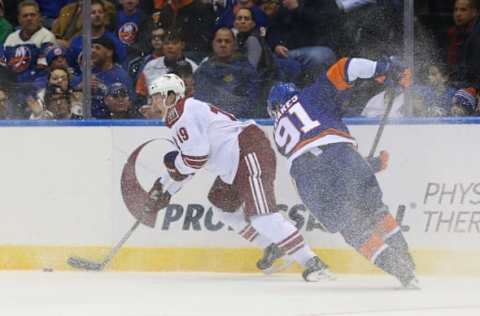 Feb 24, 2015; Uniondale, NY, USA; Arizona Coyotes right wing Shane Doan (19) keeps the puck from New York Islanders center John Tavares (91) during the third period at Nassau Veterans Memorial Coliseum. New York Islanders won 5-1. Mandatory Credit: Anthony Gruppuso-USA TODAY Sports