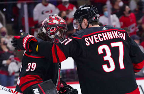 May 17, 2021; Raleigh, North Carolina, USA; Carolina Hurricanes goaltender Alex Nedeljkovic (39) and right wing Andrei Svechnikov (37) celebrate there win against the Nashville Predators in game one of the first round of the 2021 Stanley Cup Playoffs at PNC Arena. Mandatory Credit: James Guillory-USA TODAY Sports