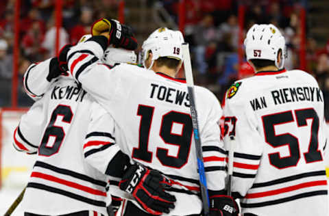 Dec 30, 2016; Raleigh, NC, USA; Chicago Blackhawks defensemen Michal Kempny (6) is congratulated by forward Jonathan Toews (19) and defensemen Trevor van Riemsdyk (57) after his first period goal against the Carolina Hurricanes at PNC Arena. Mandatory Credit: James Guillory-USA TODAY Sports