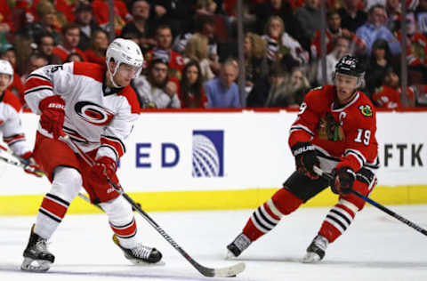 CHICAGO, IL – JANUARY 06: Noah Hanifin #5 of the Carolina Hurricanes moves against Jonathan Toews #19 of the Chicago Blackhawks at the United Center on January 6, 2017, in Chicago, Illinois. The Blackhawks defeated the Hurricanes 2-1. (Photo by Jonathan Daniel/Getty Images)