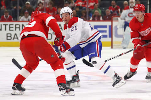 DETROIT, MICHIGAN – FEBRUARY 18: Nick Cousins #21 of the Montreal Canadiens loses control of the puck behind Trevor Daley #83 of the Detroit Red Wings during the first period at Little Caesars Arena on February 18, 2020 in Detroit, Michigan. (Photo by Gregory Shamus/Getty Images)