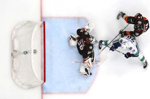 ANAHEIM, CA: John Gibson #36 and Adam Henrique #14 of the Anaheim Ducks defend against a shot by Brandon Sutter #20 of the Vancouver Canucks during the second period on March 14, 2018, in Anaheim, California. (Photo by Sean M. Haffey/Getty Images)