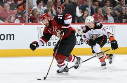 GLENDALE, AZ – APRIL 07: Derek Stepan #21 of the Arizona Coyotes advances the puck up ice ahead of Andy Welinski #73 of the Anaheim Ducks during the third period at Gila River Arena on April 7, 2018 in Glendale, Arizona. (Photo by Norm Hall/NHLI via Getty Images)