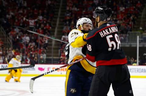 RALEIGH, NORTH CAROLINA – MAY 17: Jani Hakanpaa #58 of the Carolina Hurricanes and Mathieu Olivier #25 of the Nashville Predators scuffle following a whistle during the second period in Game One of the First Round of the 2021 Stanley Cup Playoffs at PNC Arena on May 17, 2021 in Raleigh, North Carolina. (Photo by Jared C. Tilton/Getty Images)