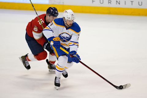 Dec 2, 2021; Sunrise, Florida, USA; Buffalo Sabres right wing Rasmus Asplund (74) skates with the puck away from Florida Panthers center Anton Lundell (15) during the third period at FLA Live Arena. Mandatory Credit: Jasen Vinlove-USA TODAY Sports