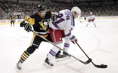 Mar 3, 2016; Pittsburgh, PA, USA; New York Rangers center Derek Stepan (21) handles the puck as Pittsburgh Penguins defenseman Olli Maatta (3) defends during the third period at the CONSOL Energy Center. The Penguins won 4-1. Mandatory Credit: Charles LeClaire-USA TODAY Sports