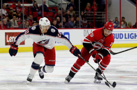 RALEIGH, NC – NOVEMBER 17: Sebastian Aho #20 of the Carolina Hurricanes and Riley Nash #20 of the Columbus Blue Jackets battle to control the puck during an NHL game on November 17, 2018 at PNC Arena in Raleigh, North Carolina. (Photo by Gregg Forwerck/NHLI via Getty Images)