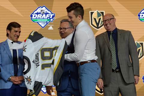 VANCOUVER, BC – JUNE 21: Peyton Krebs puts on a jersey after being selected seventeenth overall by the Vegas Golden Knights during the first round of the 2019 NHL Draft at Rogers Arena on June 21, 2019 in Vancouver, British Columbia, Canada. (Photo by Derek Cain/Icon Sportswire via Getty Images)