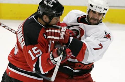 New Jersey Devils’ Jamie Langenbrunner #15 checks Carolina Hurricanes’ Niclas Wallin #7 in the first period of game four in the Eastern Conference Semifinals of the Stanley Cup Playoffs at the Continental Airlines Arena in East Rutherford, NJ on Saturday, May 13, 2006. The Devils defeated Carolina 5-1. (Photo by Richard Schultz/NHLImages)