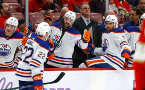 SUNRISE, FL – NOVEMBER 12: Teammates congratulate Tyson Barrie #22 of the Edmonton Oilers after he scored a second period goal against the Florida Panthers at the FLA Live Arena on November 12, 2022 in Sunrise, Florida. (Photo by Joel Auerbach/Getty Images)