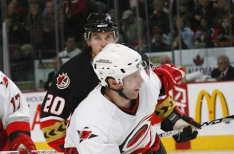 OTTAWA, CANADA – NOVEMBER 4: Erik Cole #26 of the Carolina Hurricanes skates while being pressured by Antoine Vermette #20 of the Ottawa Senators during the NHL game on November 4, 2006, at the Scotiabank Place in Ottawa, Canada. The Hurricanes won 3-2. (Photo by Phillip MacCallum/Getty Images)