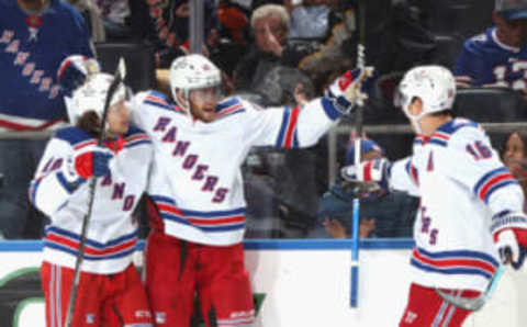 ELMONT, NEW YORK – APRIL 21: Andrew Copp #18 of the New York Rangers (C) celebrates his first-period natural hattrick against the New York Islanders and is joined by Artemi Panarin #10 (L) and Ryan Strome #16 (R) at the UBS Arena on April 21, 2022 in Elmont, New York. (Photo by Bruce Bennett/Getty Images)