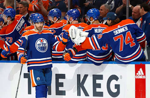 Dec 10, 2023; Edmonton, Alberta, CAN; The Edmonton Oilers celebrate a goal scored by defensemen Evan Bouchard (2) during the second period against the New Jersey Devils at Rogers Place The point was the 11th game in a row with a point for defensemen Evan Bouchard (2), an new oilers record. Mandatory Credit: Perry Nelson-USA TODAY Sports