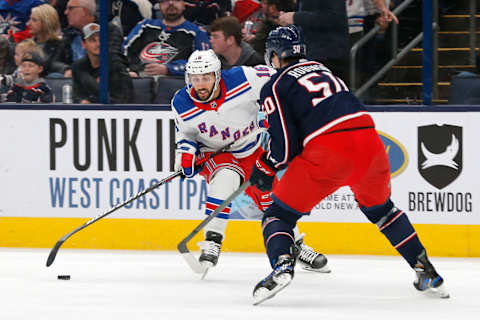 Apr 8, 2023; Columbus, Ohio, USA; New York Rangers center Vincent Trocheck (16) drags the puck past Columbus Blue Jackets left wing Eric Robinson (50) during the first period at Nationwide Arena. Mandatory Credit: Russell LaBounty-USA TODAY Sports