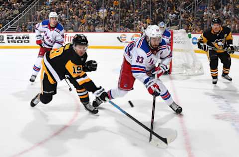 PITTSBURGH, PA – APRIL 06: Jared McCann #19 of the Pittsburgh Penguins and Mika Zibanejad #93 of the New York Rangers battle for the loose puck at PPG Paints Arena on April 6, 2019 in Pittsburgh, Pennsylvania. (Photo by Joe Sargent/NHLI via Getty Images)