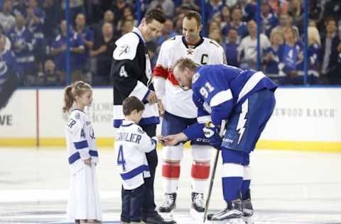 NHL Power Rankings: Former Tampa Bay Lightning plater Vincent Lecavalier (C) is honored from Tampa Bay Lightning center Steven Stamkos (91) and Florida Panthers center Derek MacKenzie (17) prior to their game at Amalie Arena. Mandatory Credit: Kim Klement-USA TODAY Sports