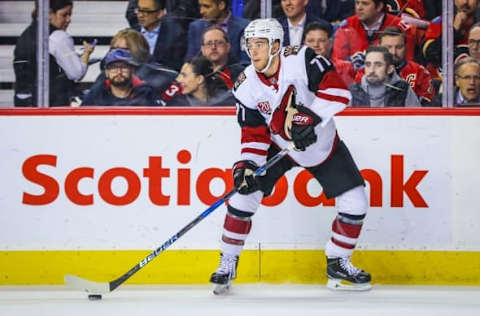 Nov 16, 2016; Calgary, Alberta, CAN; Arizona Coyotes defenseman Anthony DeAngelo (77) controls the puck against the Calgary Flames during the first period at Scotiabank Saddledome. Mandatory Credit: Sergei Belski-USA TODAY Sports