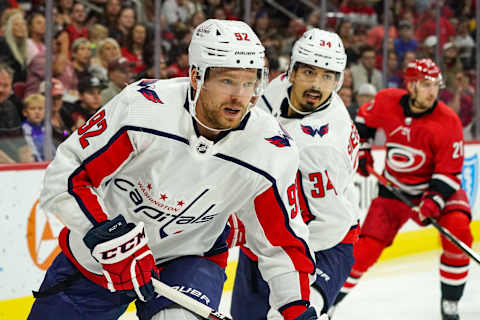 RALEIGH, NC – SEPTEMBER 29: Washington Capitals center Evgeny Kuznetsov (92) skates the puck out of the zone chased by Washington Capitals defenseman Jonas Siegenthaler (34) during an NHL Preseason game between the Washington Capitals and the Carolina Hurricanes on September 29, 2019 at the PNC Arena in Raleigh, NC. (Photo by Greg Thompson/Icon Sportswire via Getty Images)