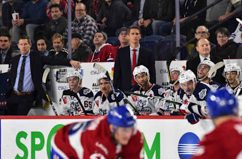 LAVAL, QC - OCTOBER 30: Head coach of the Hartford Wolf Pack Kris Knoblauch (C) watches from the bench with associate head coach Gord Murphy (L) and assistant coach David Cunniff against the Laval Rocket during the third period at Place Bell on October 30, 2019 in Laval, Canada. The Laval Rocket defeated the Hartford Wolf Pack 4-1. (Photo by Minas Panagiotakis/Getty Images)