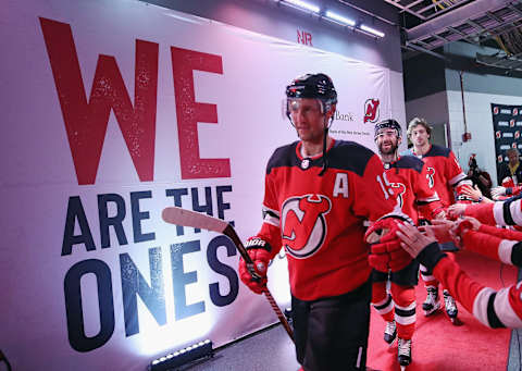 Travis Zajac leads the New Jersey Devils onto the ice in 2019. (Photo by Bruce Bennett/Getty Images)