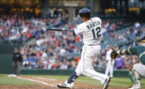 May 25, 2016; Seattle, WA, USA; Seattle Mariners center fielder Leonys Martin (12) hits an RBI-single against the Oakland Athletics during the third inningg at Safeco Field. Mandatory Credit: Joe Nicholson-USA TODAY Sports