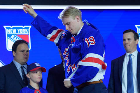 VANCOUVER, BC – JUNE 21: Kaapo Kakko puts on a jersey after being selected second overall by the New York Rangers during the first round of the 2019 NHL Draft at Rogers Arena on June 21, 2019 in Vancouver, British Columbia, Canada. (Photo by Derek Cain/Icon Sportswire via Getty Images)