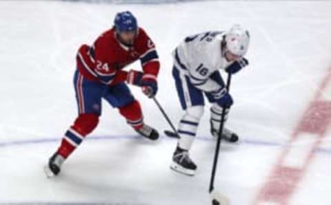 May 29, 2021; Montreal, Quebec, CAN; Toronto Maple Leafs center Mitchell Marner (16) plays the puck against Montreal Canadiens left wing Phillip Danault (24) during the first period in game six of the first round of the 2021 Stanley Cup Playoffs at Bell Centre. Mandatory Credit: Jean-Yves Ahern-USA TODAY Sports