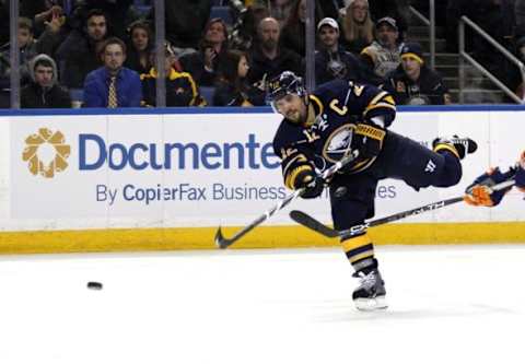 Dec 31, 2015; Buffalo, NY, USA; Buffalo Sabres right wing Brian Gionta (12) takes a shot on goal during the second period against the New York Islanders at First Niagara Center. Mandatory Credit: Timothy T. Ludwig-USA TODAY Sports