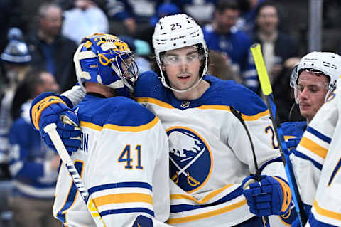 Apr 12, 2022; Toronto, Ontario, CAN; Buffalo Sabres goalie Craig Anderson (41) is greeted by defenseman Owen Power (25) as they celebrate a win over the Toronto Maple Leafs at Scotiabank Arena. Mandatory Credit: Dan Hamilton-USA TODAY Sports