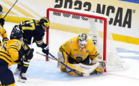 Apr 6, 2023; Tampa, Florida, USA; Quinnipiac goaltender Yaniv Perets (1) saves a shot from Michigan forward Nolan Moyle (27) during the second period in the semifinals of the 2023 Frozen Four college ice hockey tournament at Amalie Arena. Mandatory Credit: Nathan Ray Seebeck-USA TODAY Sports