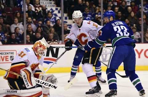 Oct 15, 2016; Vancouver, British Columbia, CAN; Calgary Flames defenseman Jyrki Jokipakka (3) and goaltender Chad Johnson (31) defend against Vancouver Canucks forward Henrik Sedin (33) during the first period at Rogers Arena. Mandatory Credit: Anne-Marie Sorvin-USA TODAY Sports