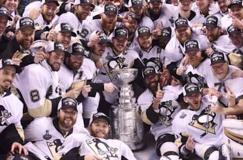 Jun 12, 2016; San Jose, CA, USA; Pittsburgh Penguins center Sidney Crosby (C) and his teammates pose for a team photo with the Stanley Cup after defeating the San Jose Sharks in game six of the 2016 Stanley Cup Final at SAP Center at San Jose. Mandatory Credit: Gary A. Vasquez-USA TODAY Sports