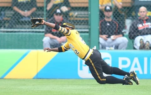 Aug 21, 2016; Pittsburgh, PA, USA; Pittsburgh Pirates center fielder Andrew McCutchen (22) makes a catch against Miami Marlins third baseman Martin Prado (not pictured) during the first inning at PNC Park. Mandatory Credit: Charles LeClaire-USA TODAY Sports