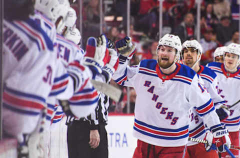 CALGARY, CANADA – FEBRUARY 18: Alexis Lafreniere #13 of the New York Rangers celebrates with the bench after scoring his team’s second goal to tie the game and force overtime against the Calgary Flames during the third period of an NHL game at Scotiabank Saddledome on February 18, 2023 in Calgary, Alberta, Canada. The Flames defeated the Rangers 3-2 in overtime. (Photo by Derek Leung/Getty Images)