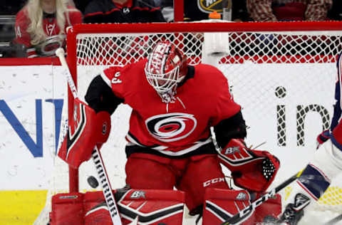 RALEIGH, NC – NOVEMBER 17: Scott Darling #33 of the Carolina Hurricanes deflects the puck away from the crease during an NHL game against the Columbus Blue Jackets on November 17, 2018 at PNC Arena in Raleigh, North Carolina. (Photo by Gregg Forwerck/NHLI via Getty Images)