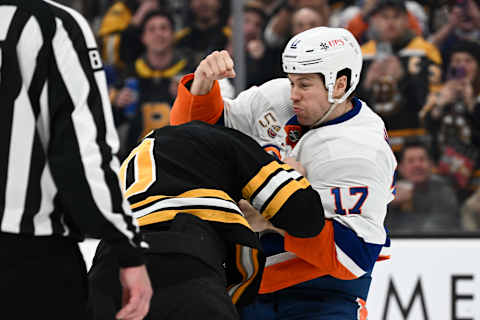 BOSTON, MASSACHUSETTS – DECEMBER 13: Matt Martin #17 of the New York Islanders fights A.J. Greer #10 of the Boston Bruins during the second period at the TD Garden on December 13, 2022, in Boston, Massachusetts. (Photo by Brian Fluharty/Getty Images)