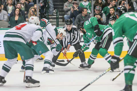 DALLAS, TX – OCTOBER 19: Referee drops the puck on a face-off during the game between the Dallas Stars and Minnesota Wild on October 19, 2018 at the American Airlines Center in Dallas, TX. (Photo by George Walker/Icon Sportswire via Getty Images)