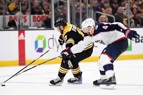 Dec 17, 2022; Boston, Massachusetts, USA; Boston Bruins left wing Nick Foligno (17) controls the puck ahead of Columbus Blue Jackets defenseman Vladislav Gavrikov (4) during the third period at TD Garden. Mandatory Credit: Bob DeChiara-USA TODAY Sports