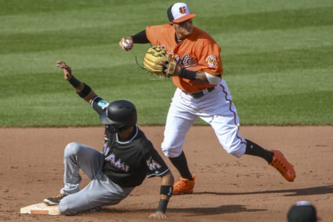 BALTIMORE, MD – JUNE 16: Baltimore Orioles shortstop Manny Machado (13) completes a double play forcing Miami Marlins center fielder Lewis Brinson (9) out during the interleague game between the Miami Marlins and the Baltimore Orioles on June 16, 2018, at Orioles Park at Camden Yards in Baltimore, MD. The Miami Marlins defeated the Baltimore Orioles, 5-4. (Photo by Mark Goldman/Icon Sportswire via Getty Images)