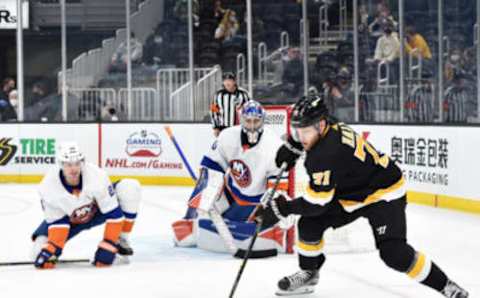 Apr 16, 2021; Boston, Massachusetts, USA; Boston Bruins left wing Taylor Hall (71) controls the puck in front of New York Islanders goaltender Ilya Sorokin (30) while defenseman Scott Mayfield (24) defends during the second period at TD Garden. Mandatory Credit: Bob DeChiara-USA TODAY Sports