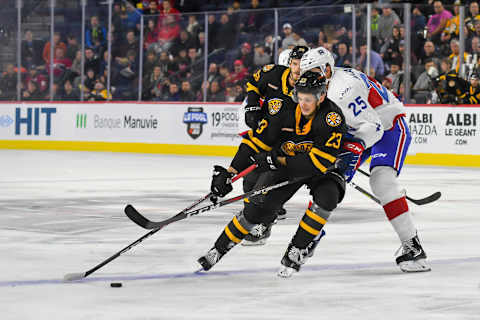 LAVAL, QC, CANADA – OCTOBER 16: Jack Studnicka #23 of the Providence Bruins controls the puck while Michael McCarron #25 of the Laval Rocket applying pressure at Place Bell on October 16, 2019 in Laval, Quebec. (Photo by Stephane Dube /Getty Images)